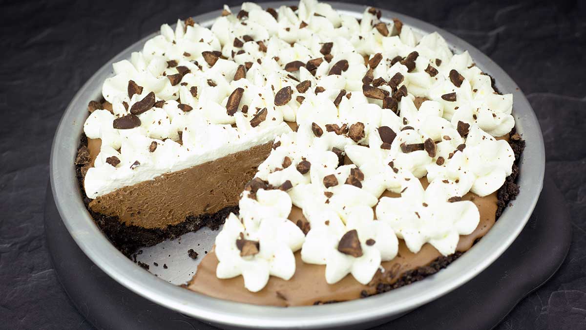chocolate mousse pie in a pie pan with one slice removed