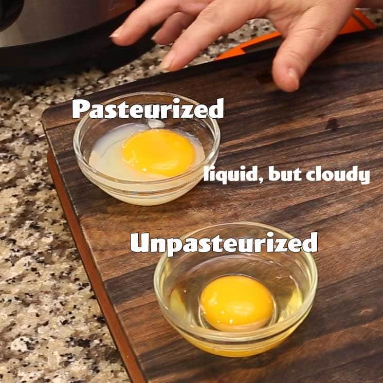 one pasteurized egg in a small bowl being compared to an unpasteurized egg. The pasteurized egg white is cloudy and a touch firmer