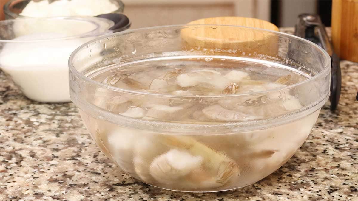 thawing shrimp in a bowl of cold water