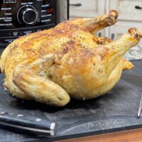 Ninja Foodi Whole Chicken sitting on cutting board