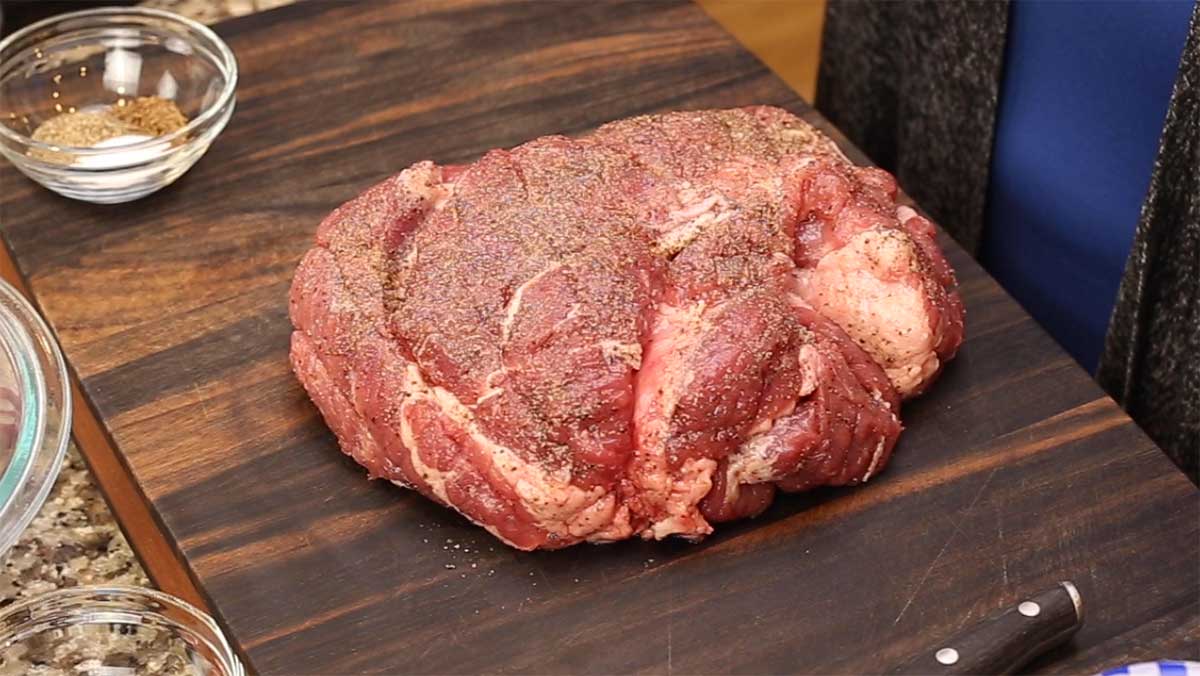 seasoned pork shoulder on a cutting board
