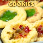 cheddar cheese thumbprint cookies on a tray with various toppings