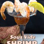 Shrimp cocktail in a margarita glass with a 4 shrimp and a lemon wedge