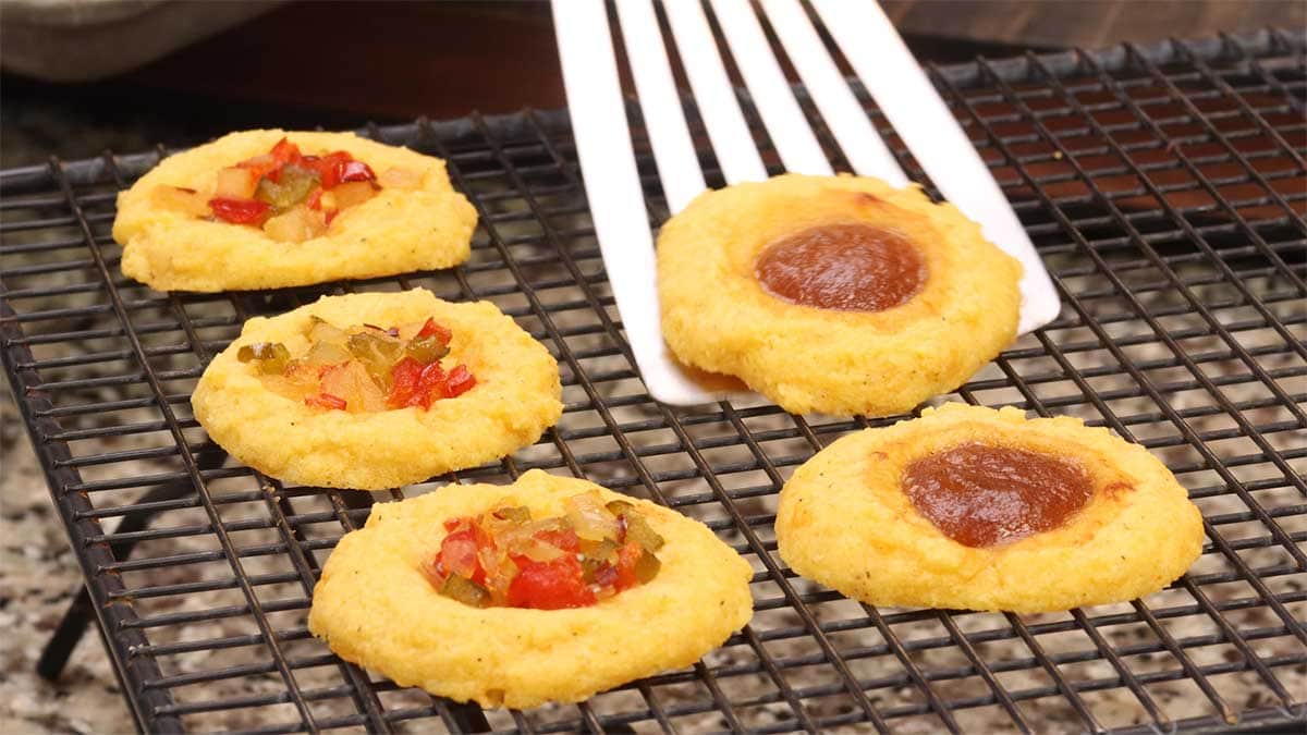 Putting the cheddar cheese cookies on a cooling rack after baking