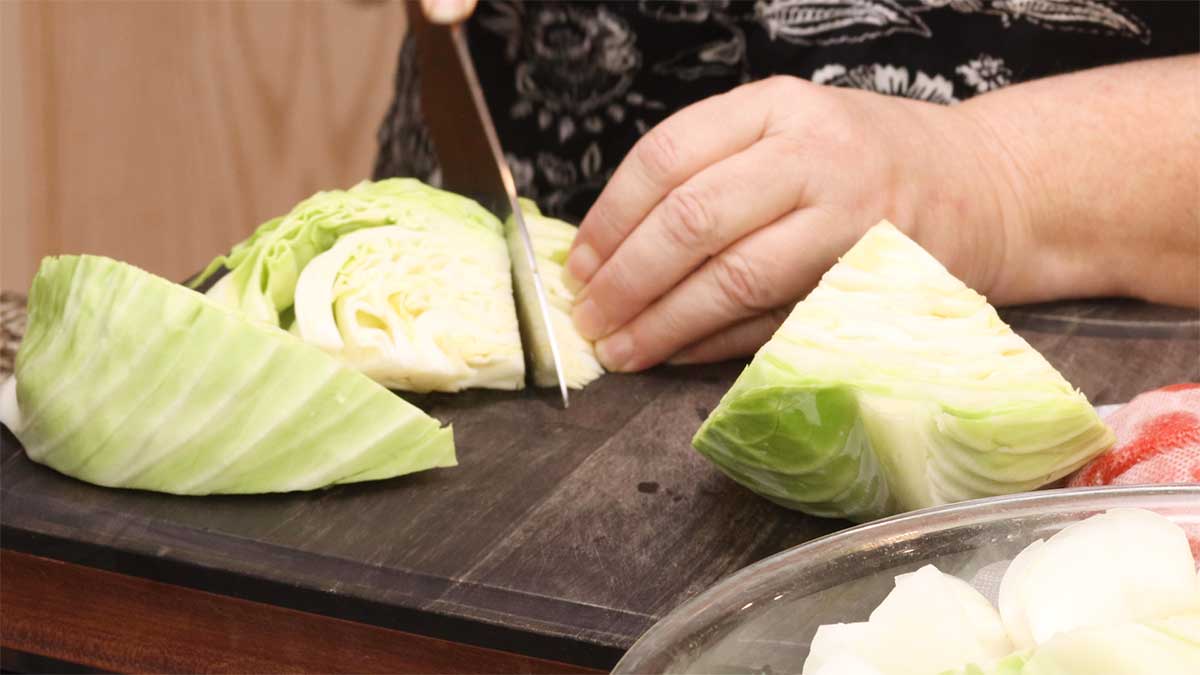 cutting up the cabbage into large chunks