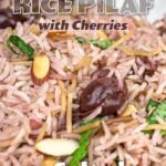 almond rice pilaf with cherries in a white bowl.