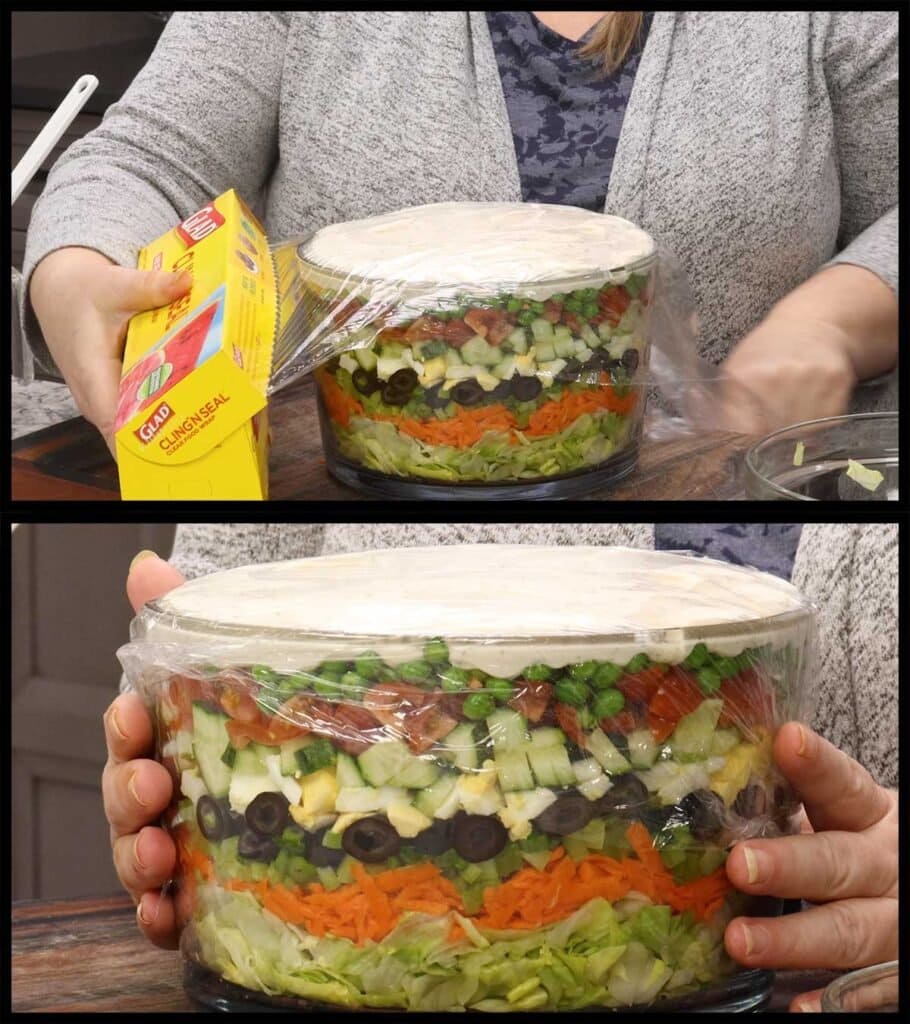 covering the layered salad with plastic wrap.