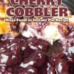 cherry cobbler on a black plate.