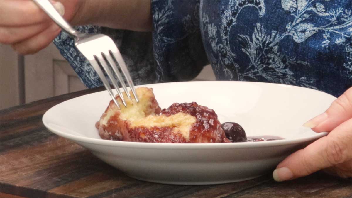 Cherry Cobbler in a white bowl with fork.