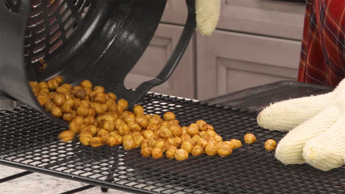 dumping chickpeas onto a cooling raack.