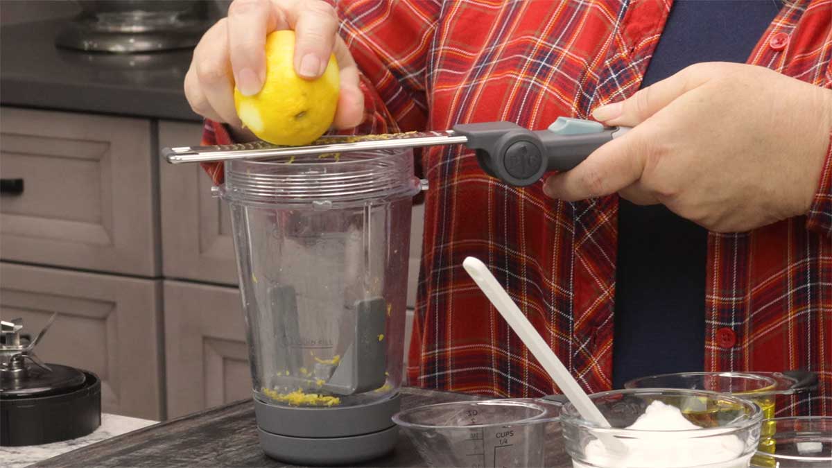 zesting lemon into blender cup.