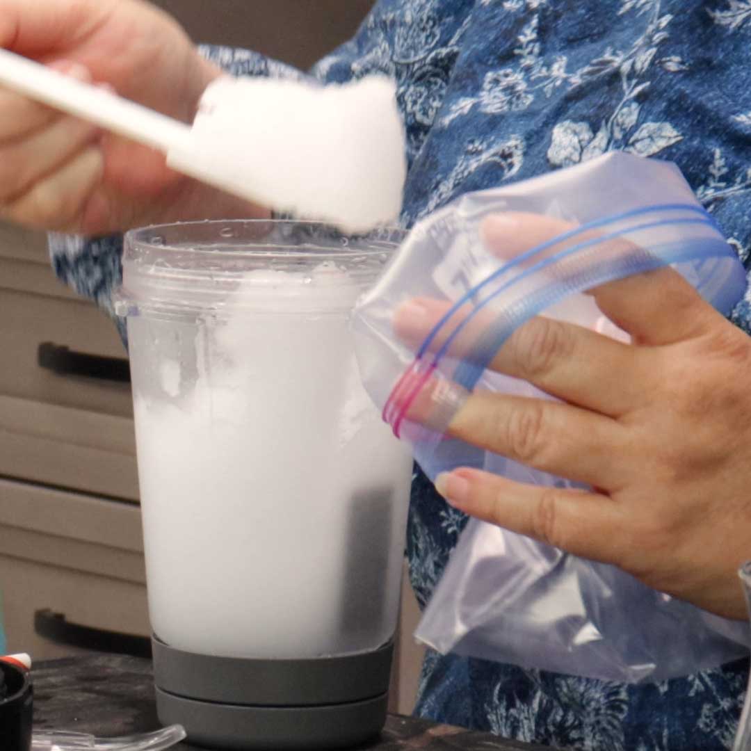 placing the limeade slushy into freezer bag.