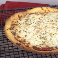 Crispy Keto Pizza Cooked and on a cooling rack.