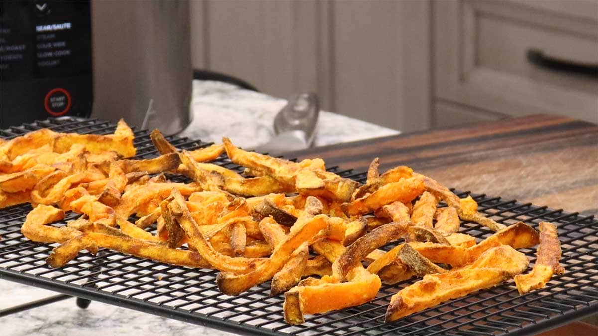 Sweet Potato Fries spread out on cooling rack and ready to eat.