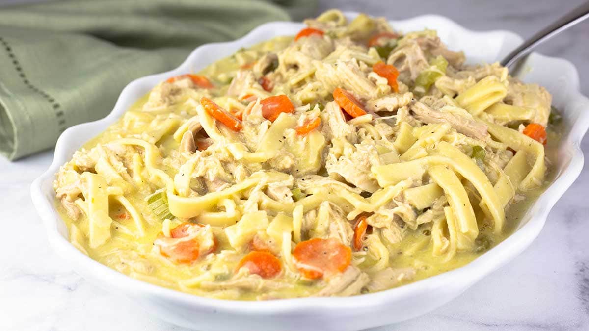 chicken and noodles in a white serving bowl. 
