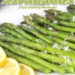 Steamed Asparagus on a white plate with lemon slices.
