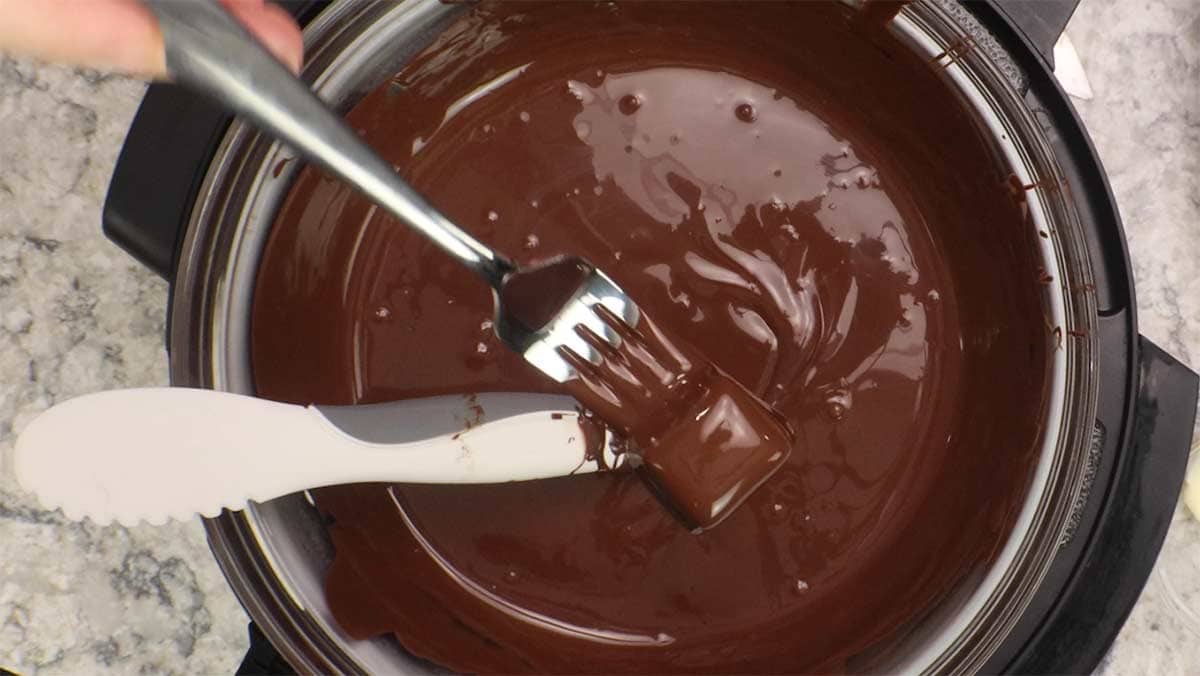 caramel candy coming out of smooth dipping chocolate.