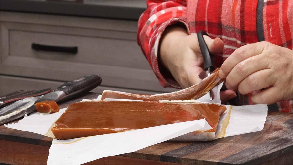 cutting caramel with scissors.
