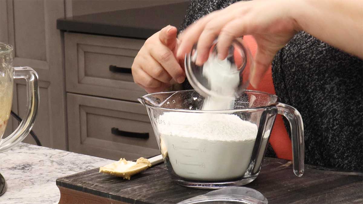 mixing baking powder and salt into flour. 