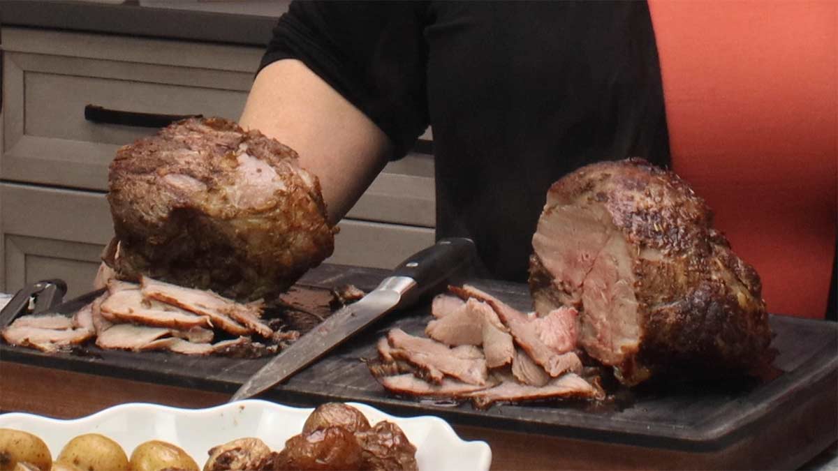 both lamb legs after cooking and sliced side by side.