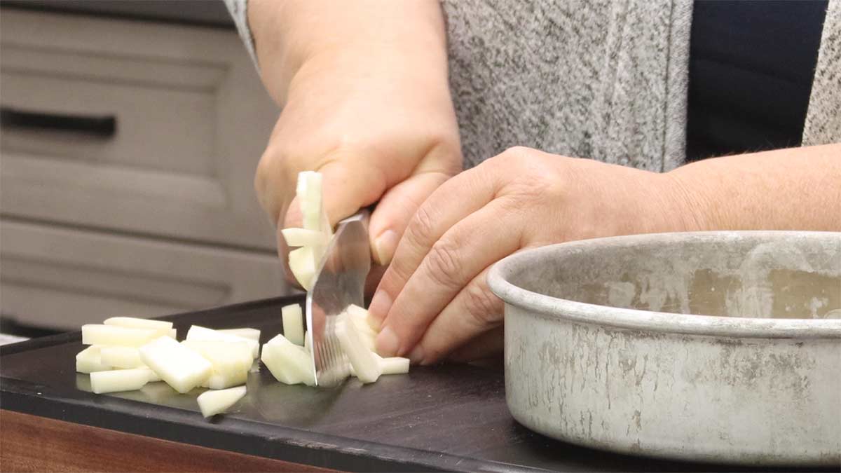 cutting the potatoes into small pieces.