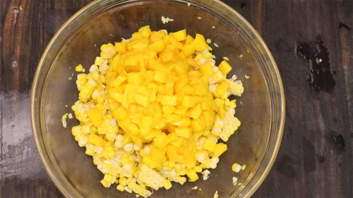 mango and corn in mixing bowl to make salsa. 
