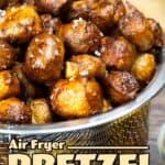 Air fryer pretzel bites in a mesh basket next to cheddar cheese sauce.