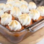 Slow Cooker Candied Sweet Potatoes in a glass dish with golden meringue on top.