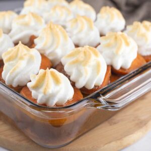 Slow Cooker Candied Sweet Potatoes in a glass dish with golden meringue on top.