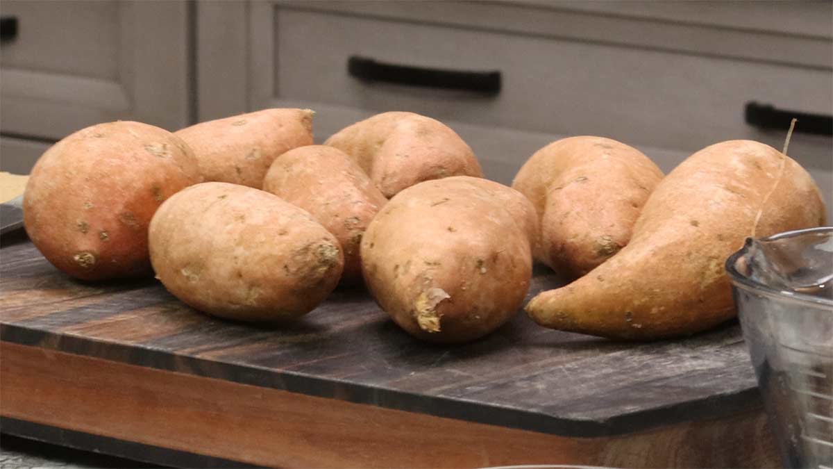 small sweet potatoes on a cutting board.
