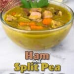 A bowl of pressure cooked split pea soup with ham sitting beside a basket of rolls and butter.