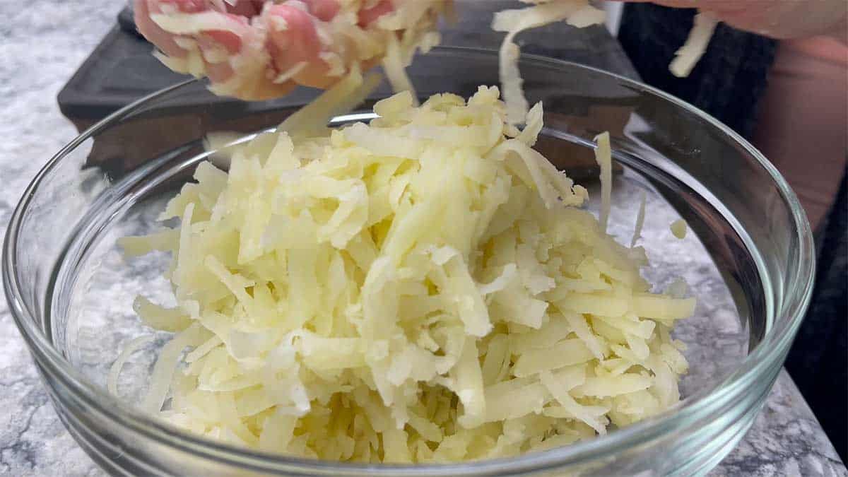 large bowl of grated potatoes.