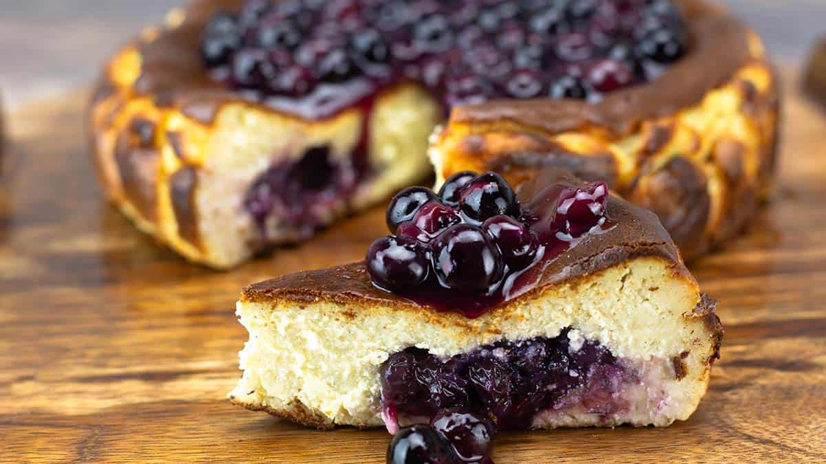 blueberry basque cheesecake on wood board.