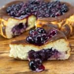 blueberry basque cheesecake on wood board.