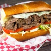 Chopped Beef Sandwich with lettuce, tomato, and cheese.