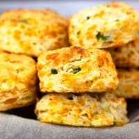 Cheddar Jalapeno Biscuits stacked in basket.