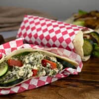 Homemade pita pocket stuffed next to a pita being used as a shawarma wrap.