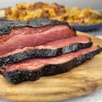 Smoked Corned Beef sliced on cutting board.