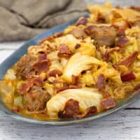 Smothered Cabbage with crispy bacon on top on platter.
