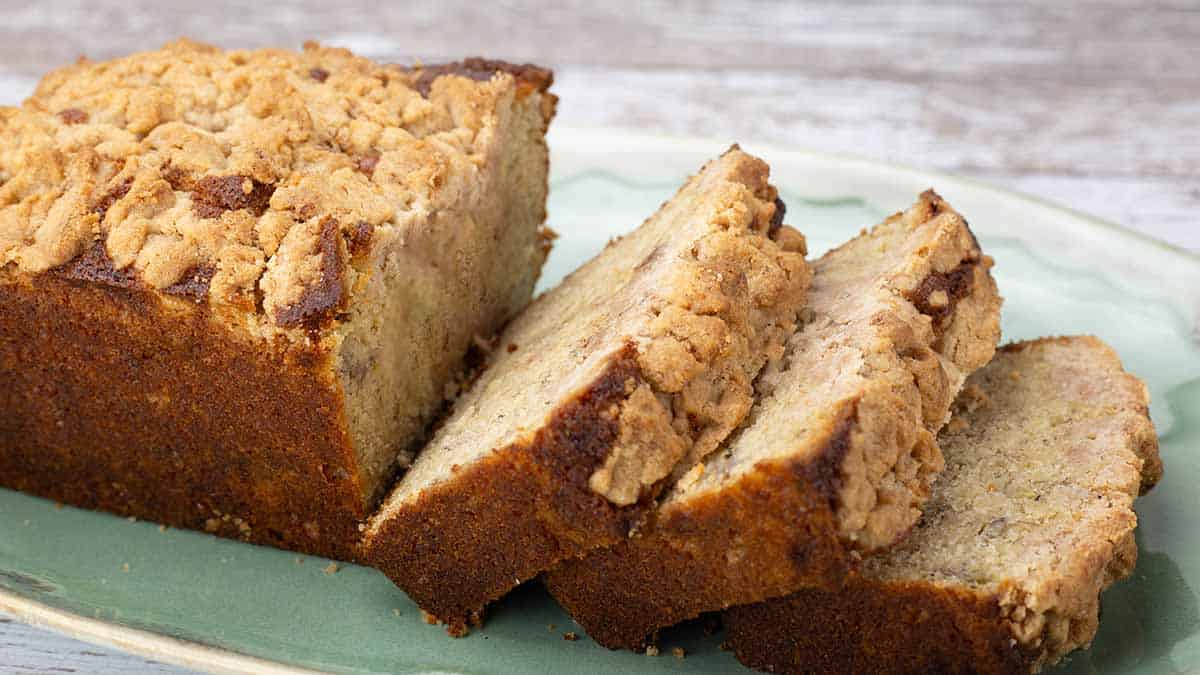 Banana Bread Coffee Cake sliced on a green platter.