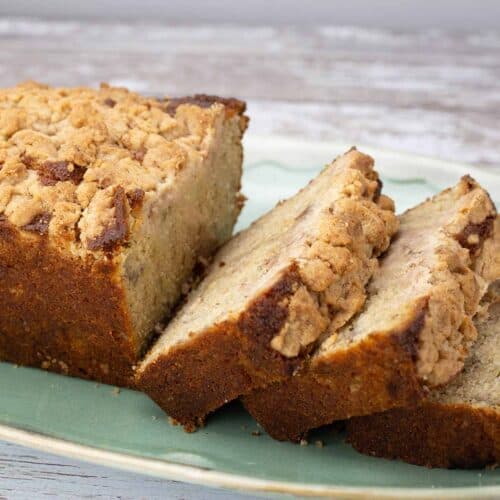 Banana Bread Coffee Cake sliced on a green platter.