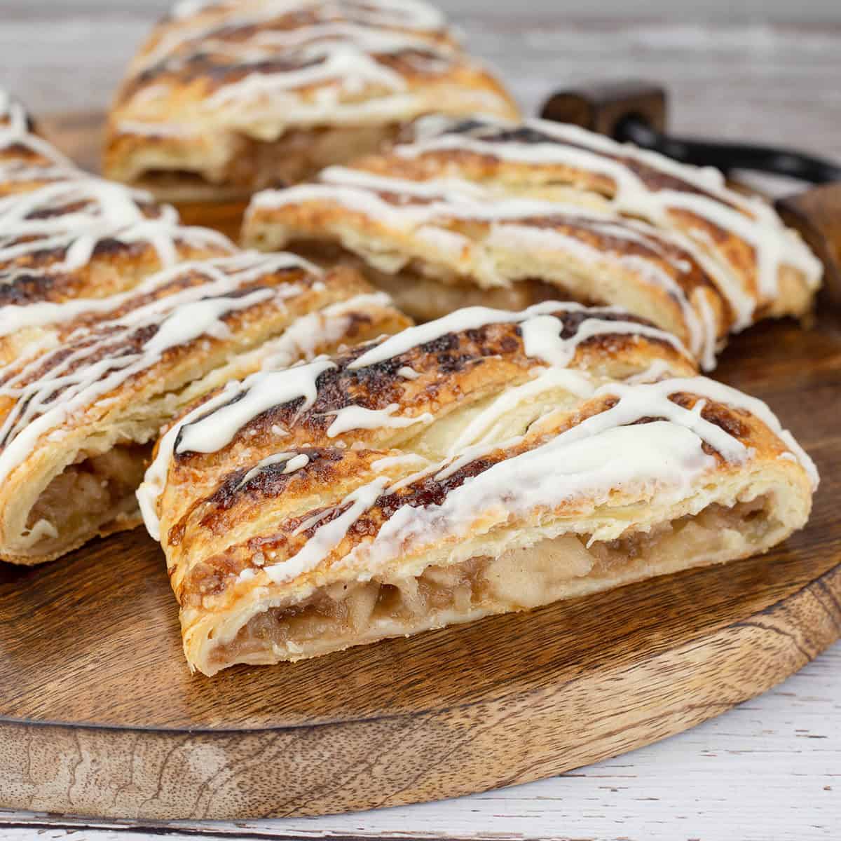 Apple Puff Pastry cut on a wooden board.