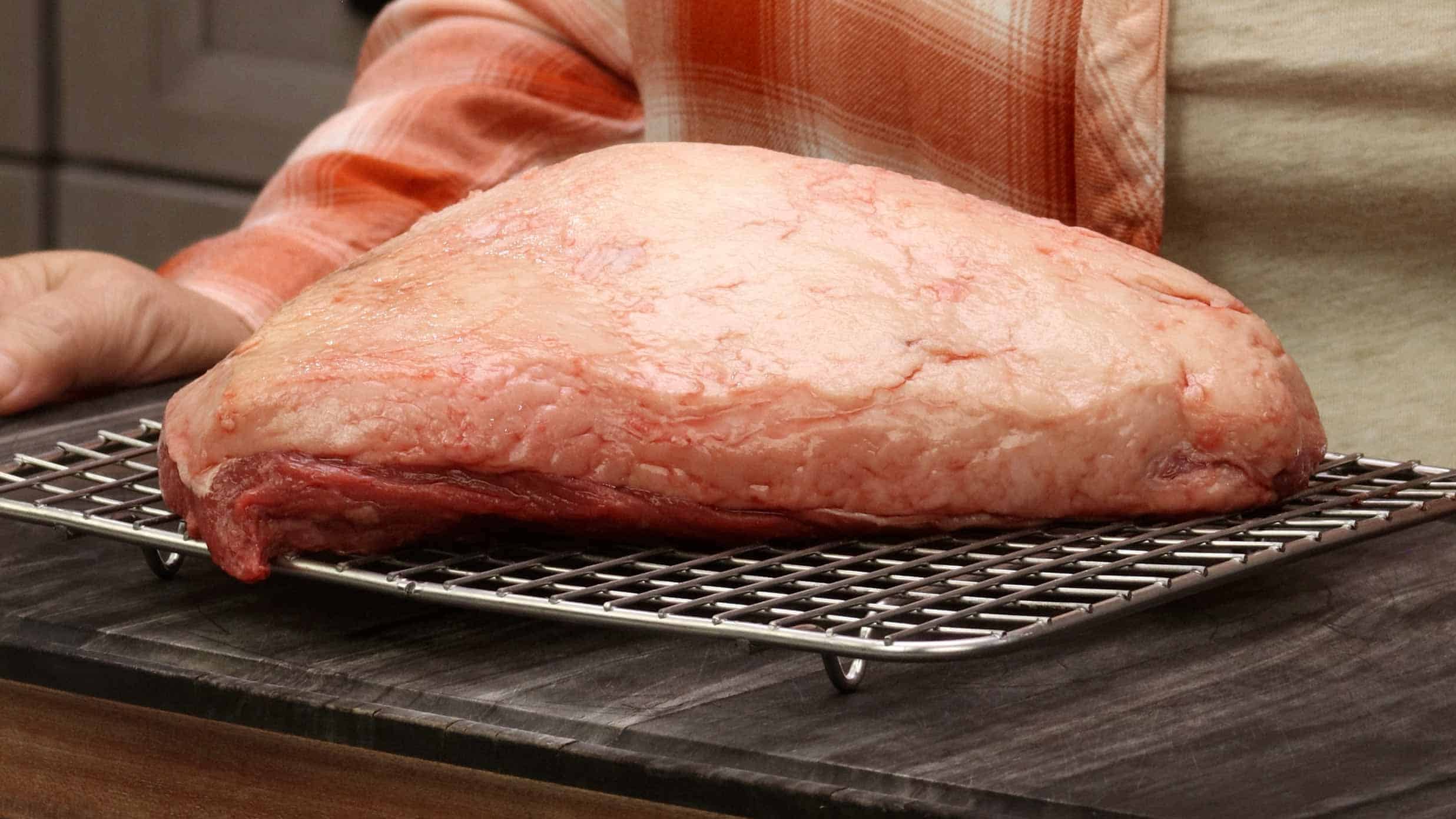 Raw picanha roast showing fat cap on cutting board