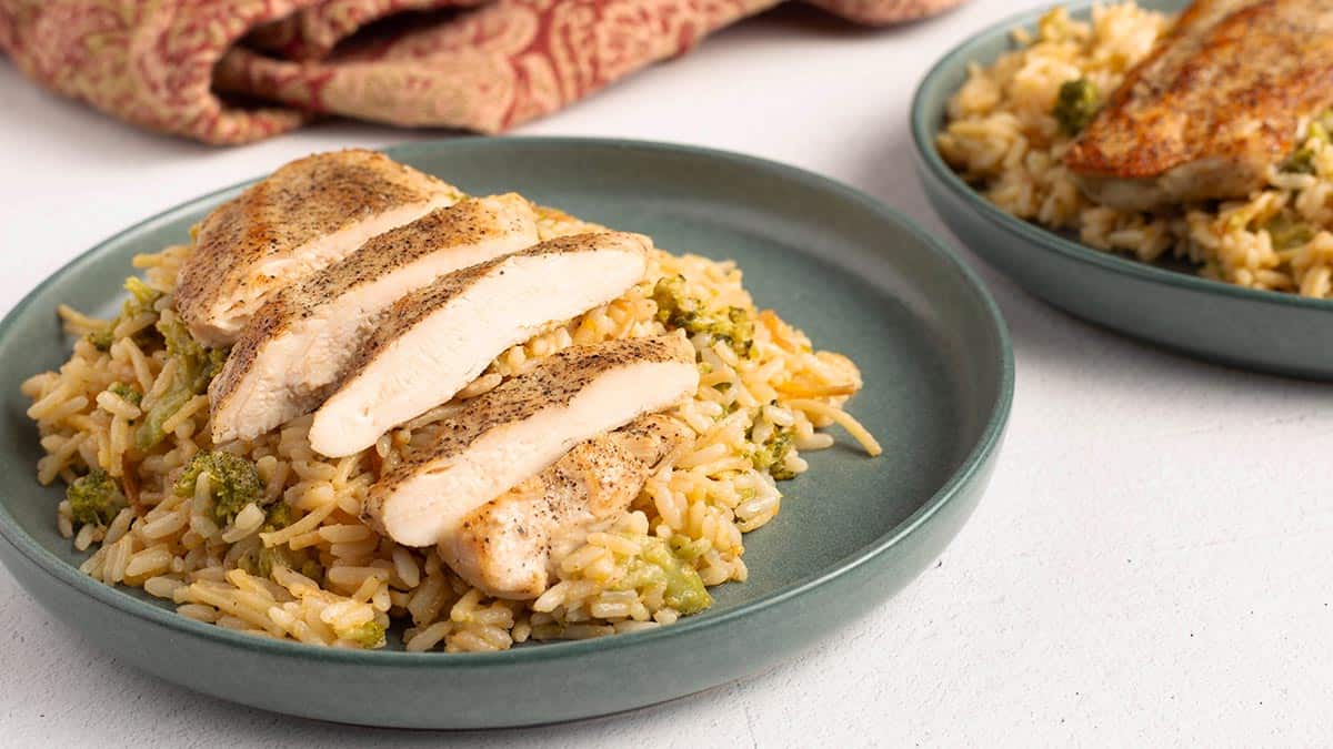 Plated cheesy rice a roni with chicken and broccoli.