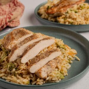 Plated cheesy rice a roni with chicken and broccoli.