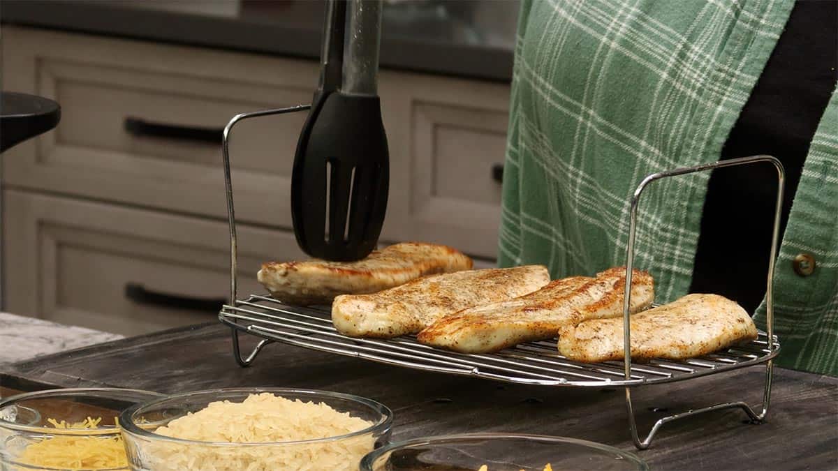 removing seared chicken after searing and putting it on the steam rack.