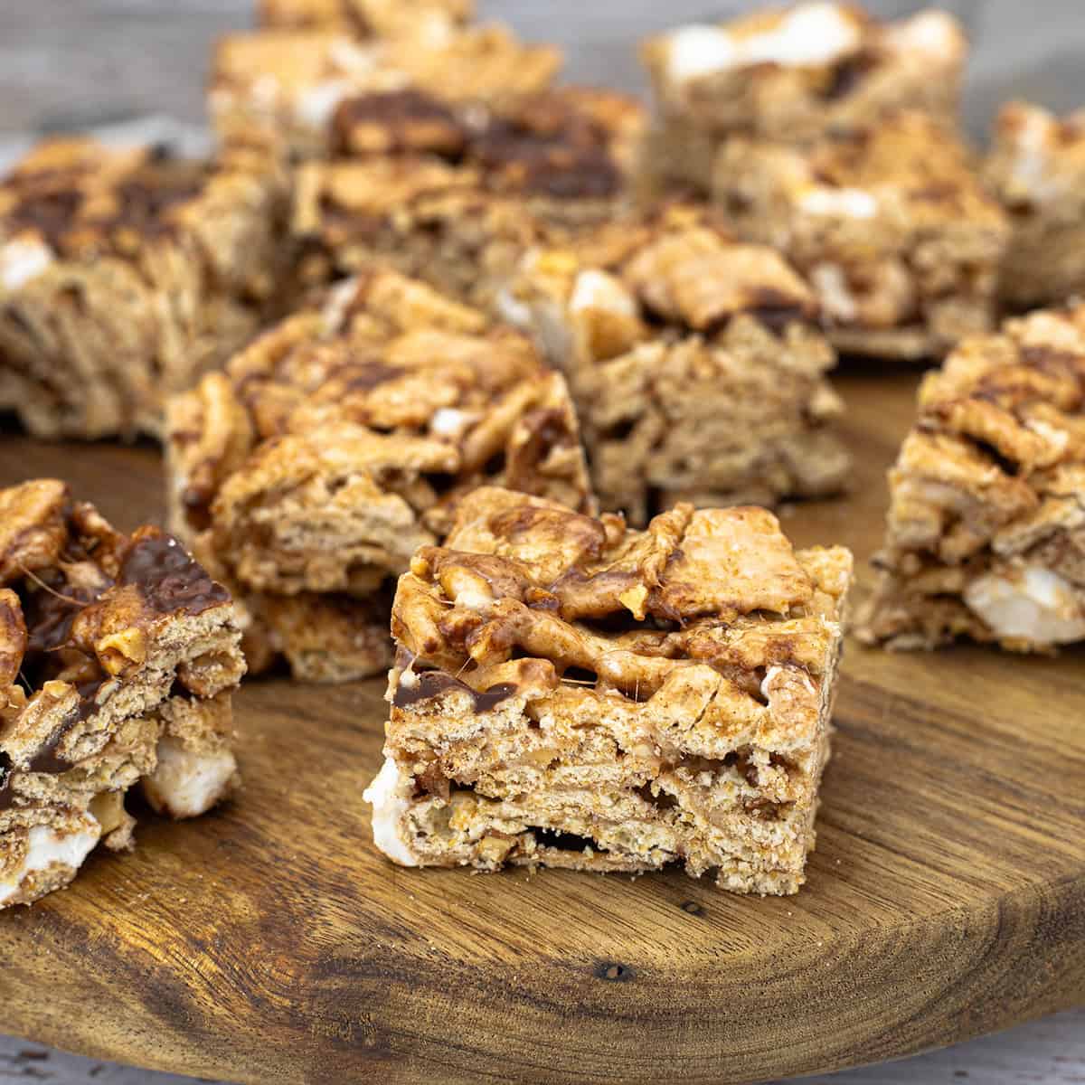 Cinnamon Toast Crunch bars cut into squares and displayed on parchment paper in a square format