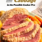 sliced Corned Beef and Cabbage with Potatoes and Carrots on a green platter.