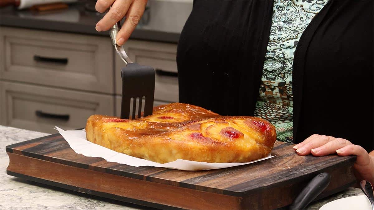 cutting Pineapple upside down cake.