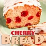 Sliced cherry bread loaf glazed with white icing and topped with a maraschino cherry, displayed on a green platter with a golden napkin and fork.